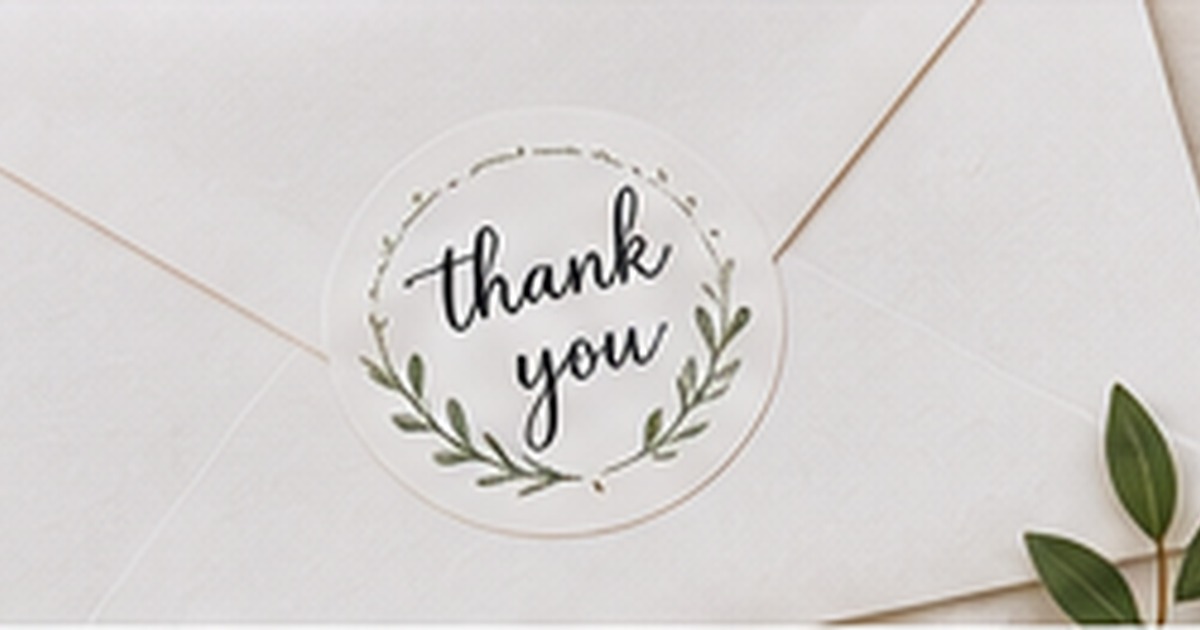 Minimal thank-you envelope sealed with a round botanical sticker